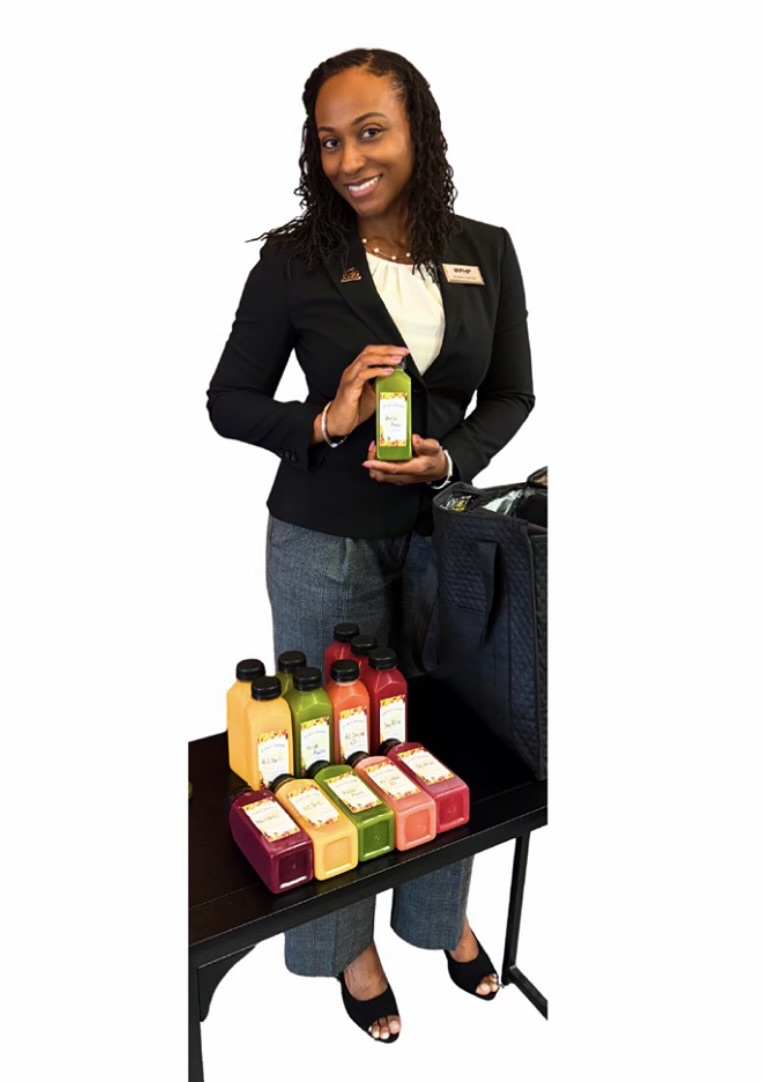 Kay holding a Kay Joy cold press juice bottle